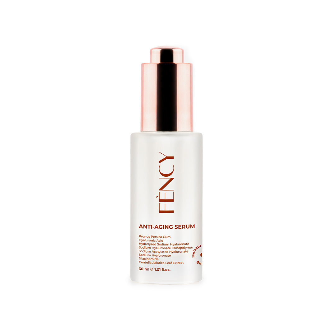 A bottle of ANTI AGING SERUM with a white body and a rose gold cap.